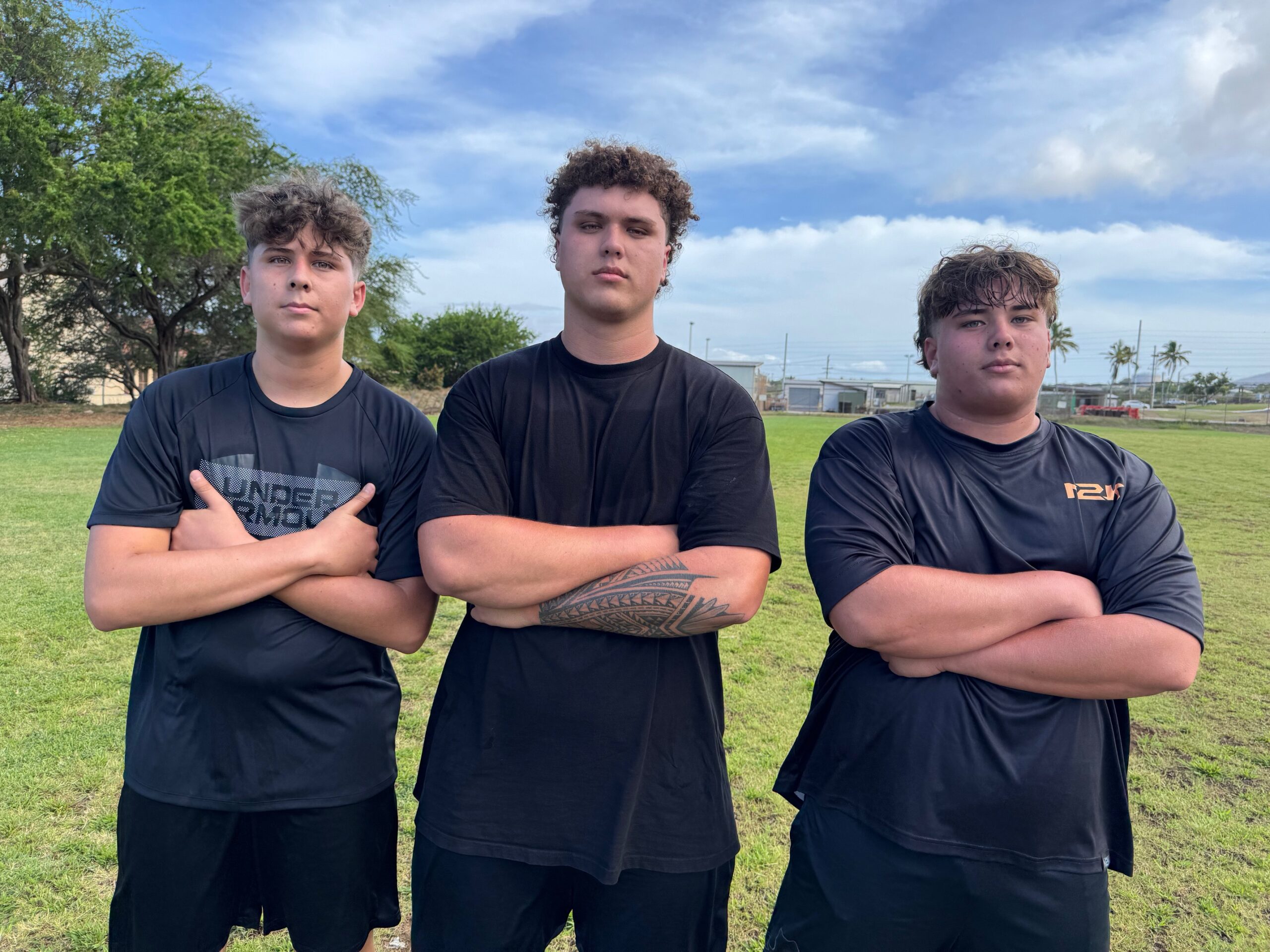 The Krau brothers, from left, Vaidan, Kaholi and Braxton, were at football practice together for the first time in their lives on Monday at Baldwin High School. HJI / ROB COLLIAS photo