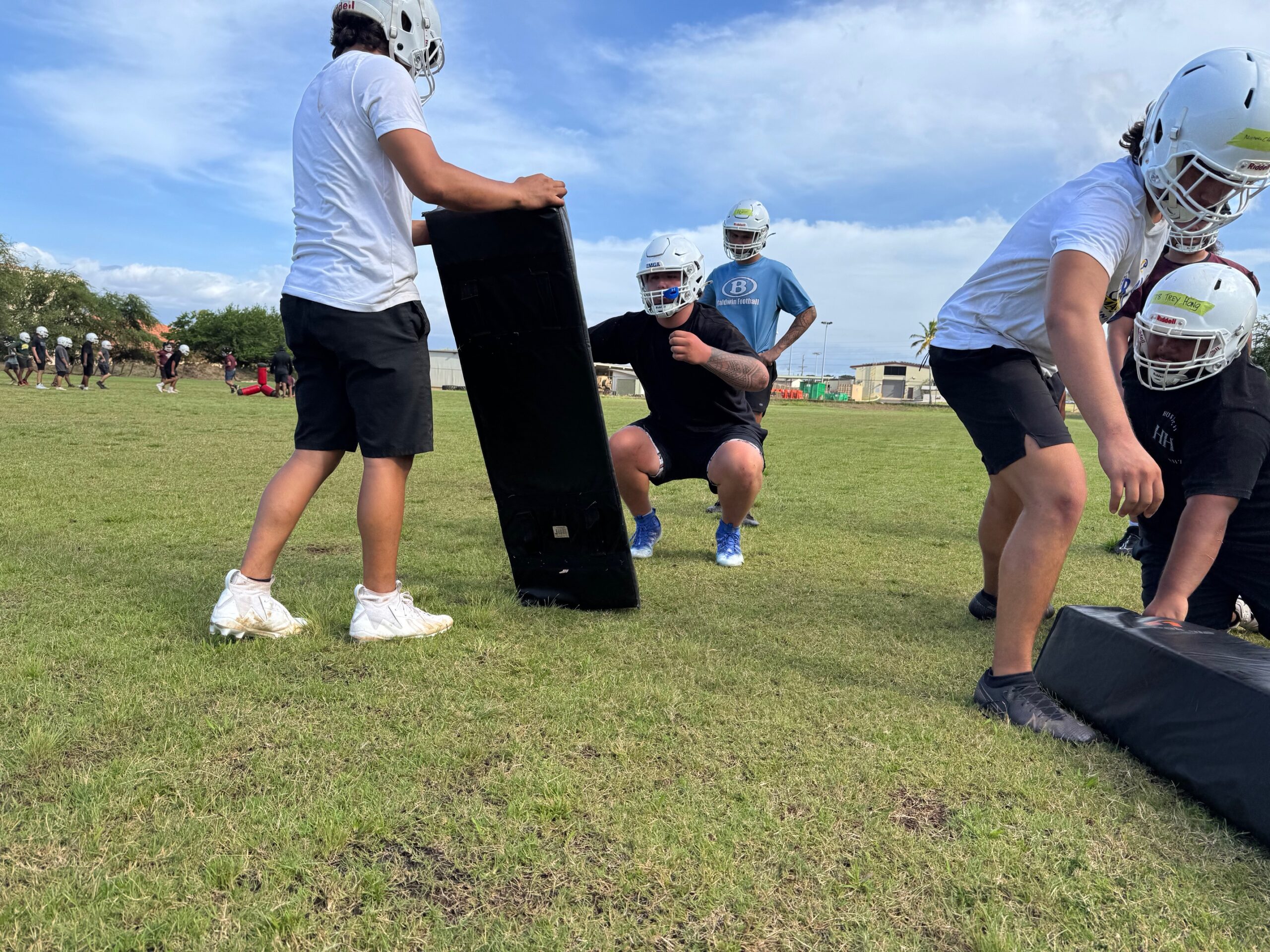 Kaholi Krau (black shirt) gets ready to do a tackling drill at Baldwin High School football practice on Monday. HJI / ROB COLLIAS photo