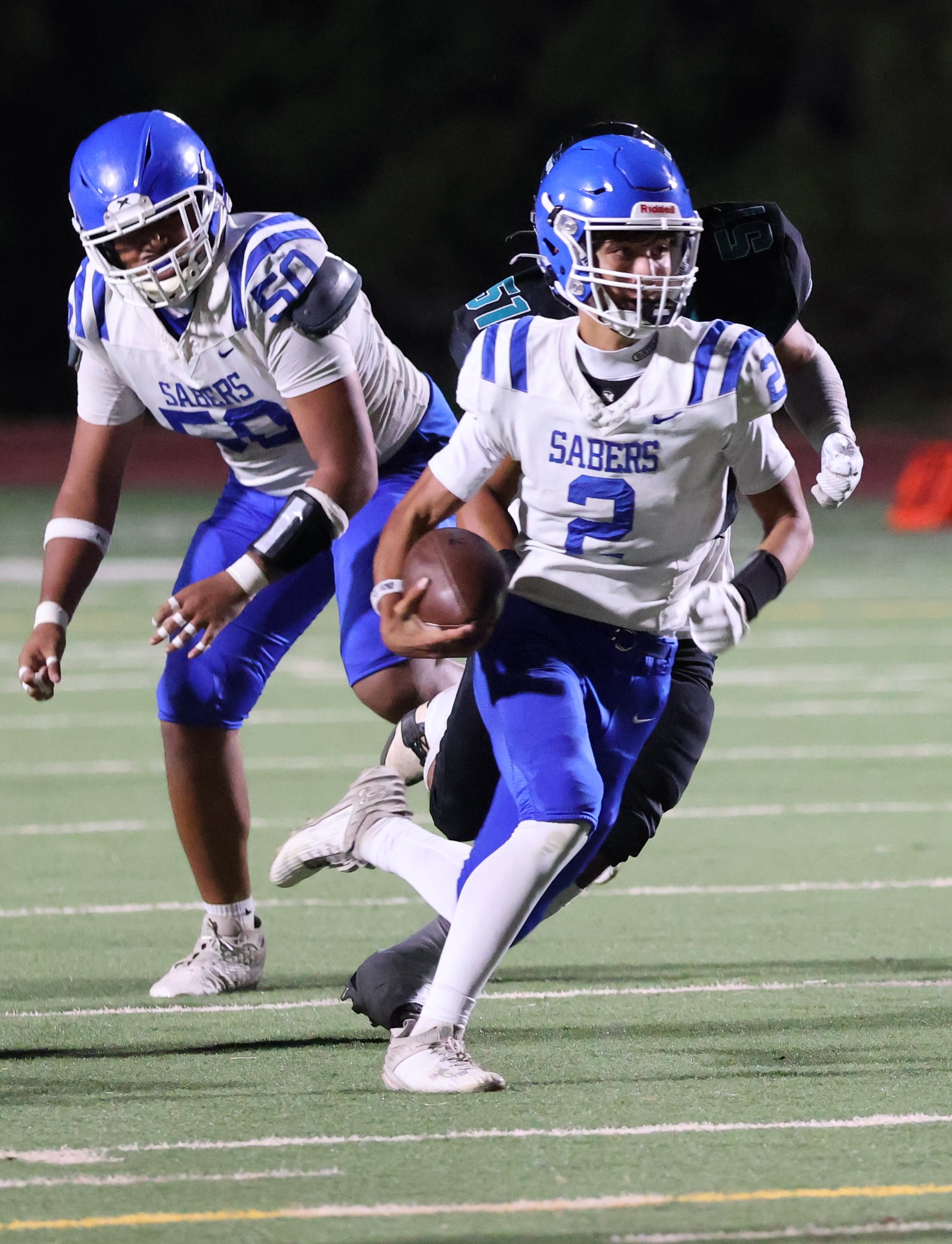 Maui High School quarterback Kahlen Boteilho-Dougherty runs against King Kekaulike Friday night in the Maui Interscholastic League football opener. Na Ali'i won the game 41-20. REID YAMAMOTO photo