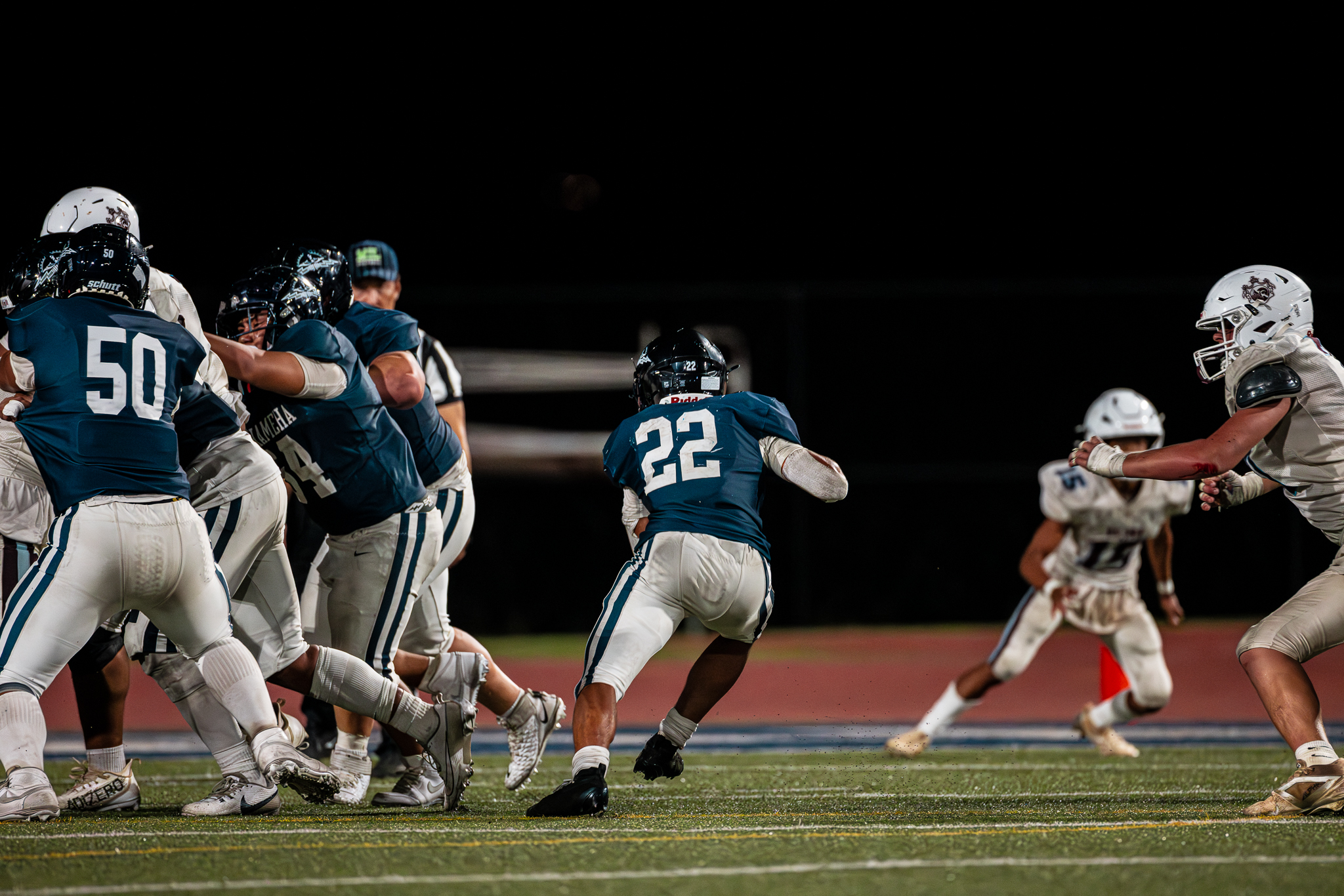 Zedekaiah Campbell (22) of Kamehameha Maui carries the ball in the Warriors' 28-21 win over Baldwon on Saturday. Campbell became the Kamehameha Maui's all-time leading rusher in the game. He now has 1,519 yards rushing in his three-season varsity career. XYLER NAKAMURA photo