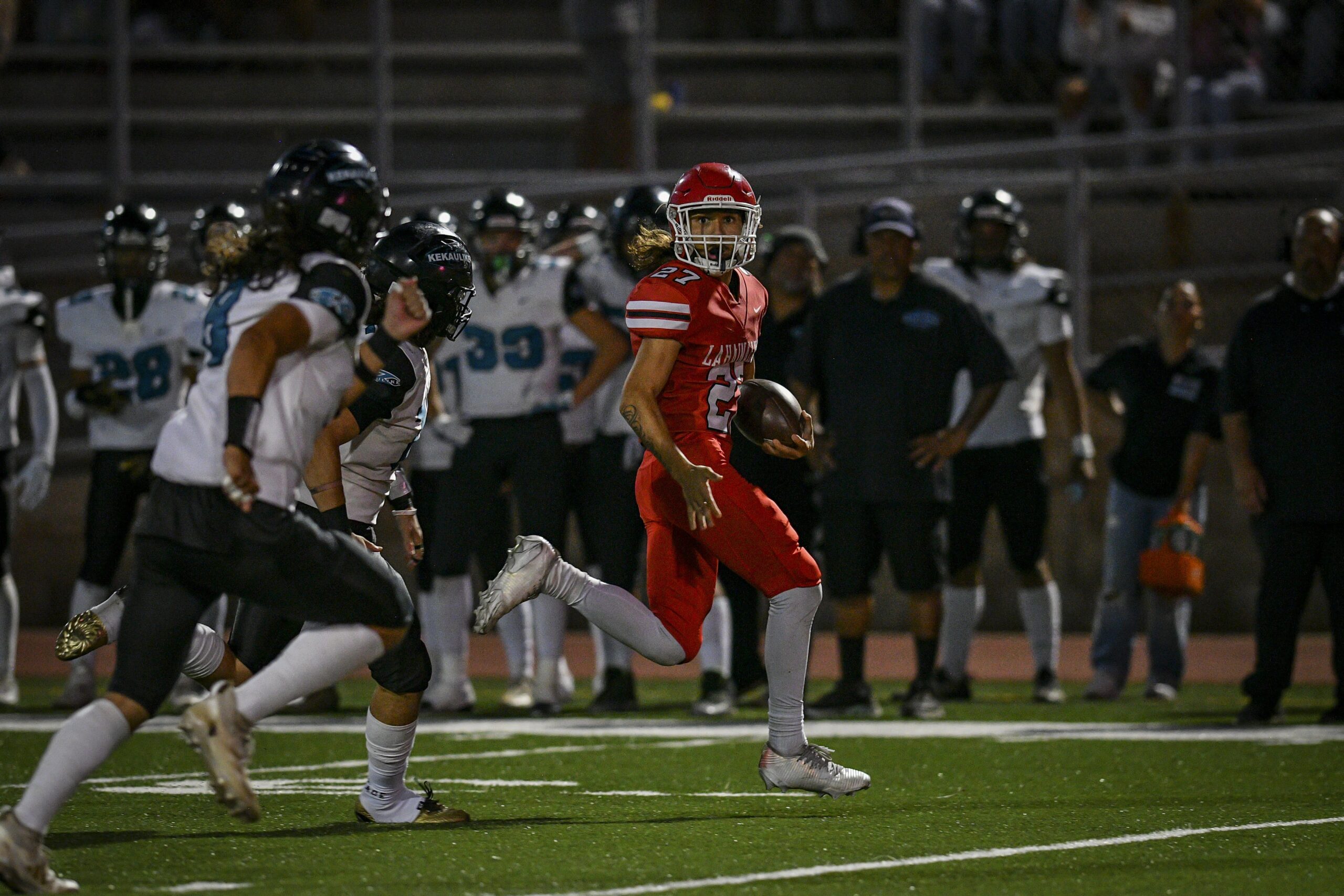 Lahainaluna High School's Ezekiel Opunui outruns the King Kekaulike defenders on one of Opunui's two touchdown runs on Friday night. GLEN PASCUAL photo