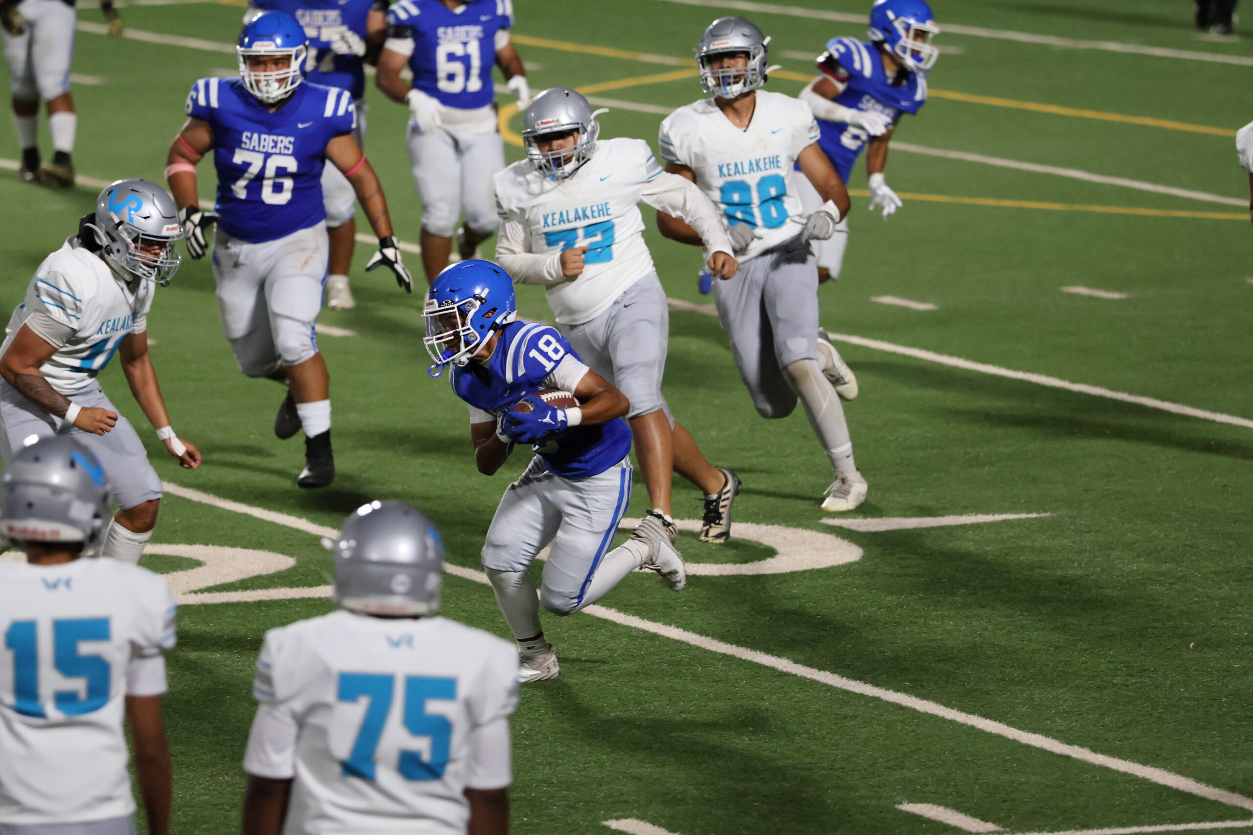 Maui High School's Noah Shepard (18) runs after one of his six catches for 67 yards in the Sabers' 21-6 win over Kealakehe on Saturday night at King Kekaulike Stadium. REID YAMAMOTO photo