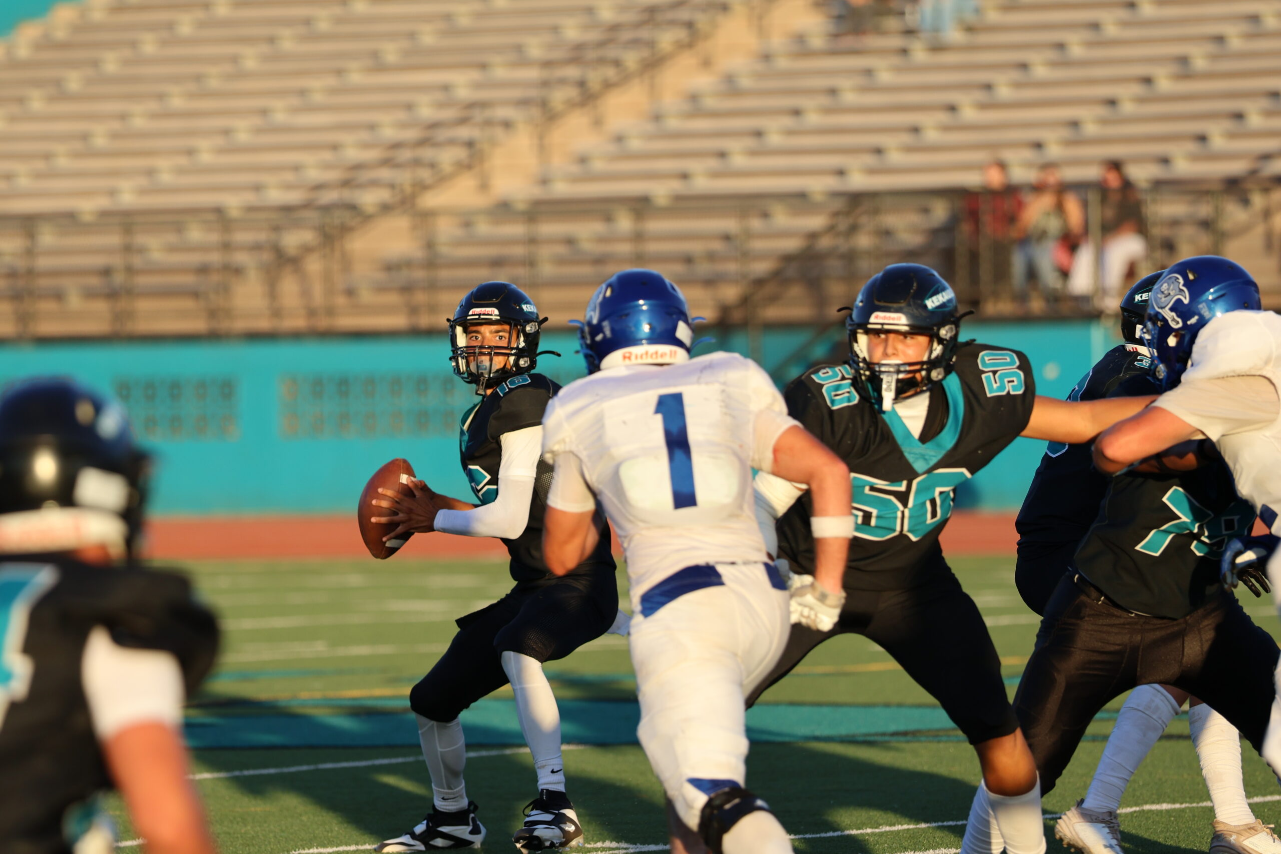 King Kekaulike quarterback Kingston Goliday prepares to throw as Moro Bay's Luca Macari (1) rushes against Jonah Shim (50). Na Ali'i won the game 68-41. REID YAMAMOTO photo