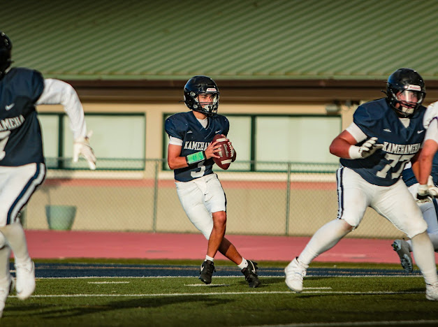 Kamehameha Schools Maui quarterback Kekoa Keau-Davis drops back to pass in a 33-17 loss to Damien on Aug. 8 while Pa'u Spencer (77) blocks. HEZEKIAH KAPUA'ALA photo