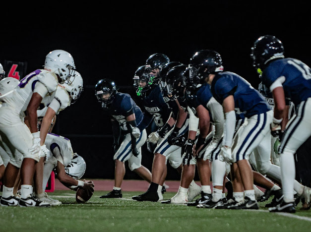 The Kamehameha Schools Maui football team (in blue) lines up as the Damien team prepares to punt on Friday night at Kanaiaupuni Stadium. The Monrachs beat the Warriors 33-17 in the preseason oepner for both. HEZEKIAH KAPUA'ALA photo