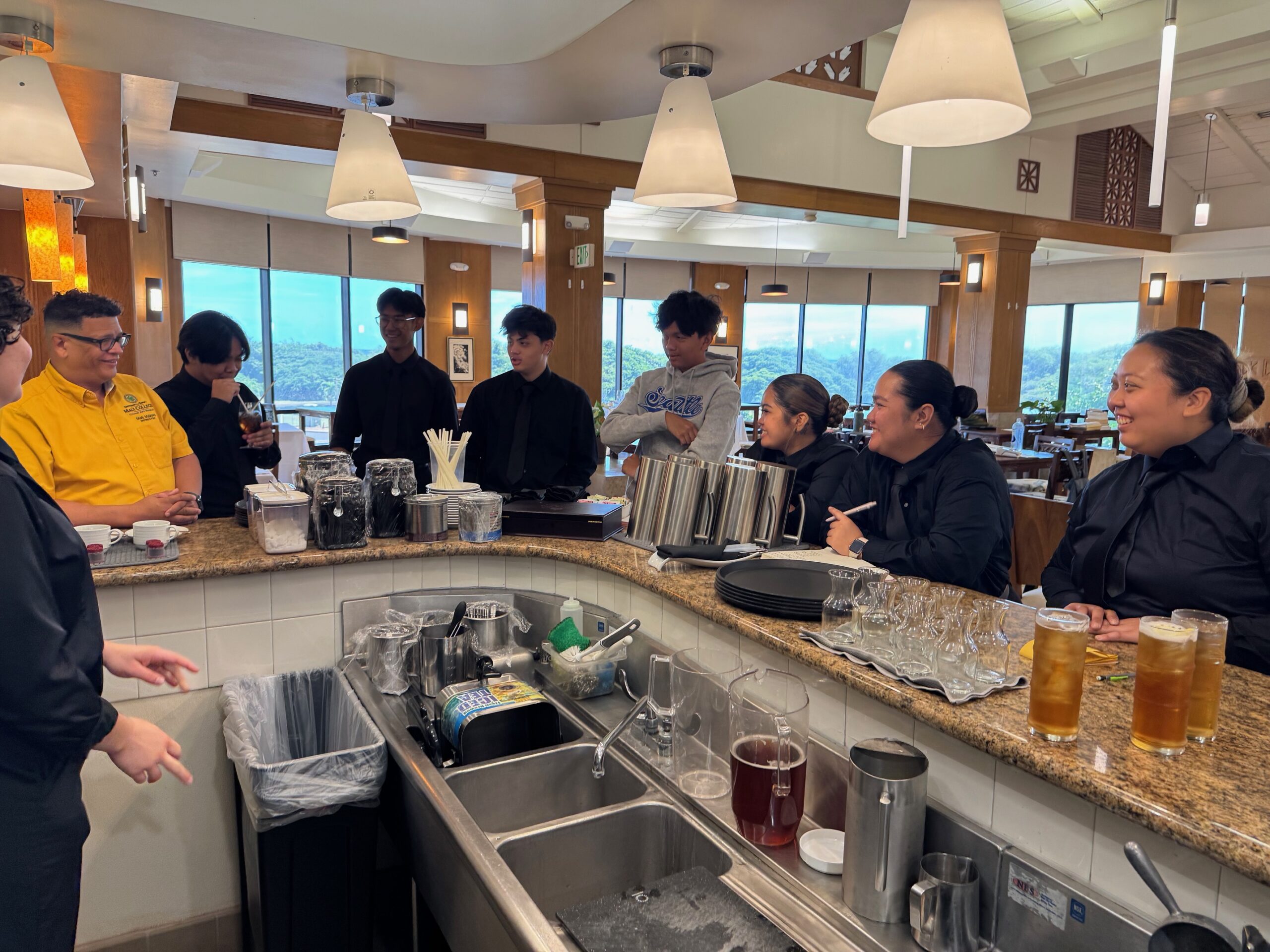 The dining room service class at the University of Hawai'i Maui College meets in the Leis Family Class Act dining room with instructor Mark Malone (yellow shirt) on Friday. HJI / ROB COLLIAS photo