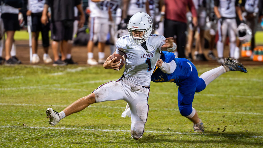 Baldwin High School quarterback Jordan Carbonell is tackled in the Bears' 17-13 win over Hilo on Friday night at Wong Stadium on Hawai'i Island. Carbonell kicked a field goal, was 11-for-20 passing for 143 yards and ran 10 times for 13 yards. Delfin Kamakoa Paulo-Galsote photo