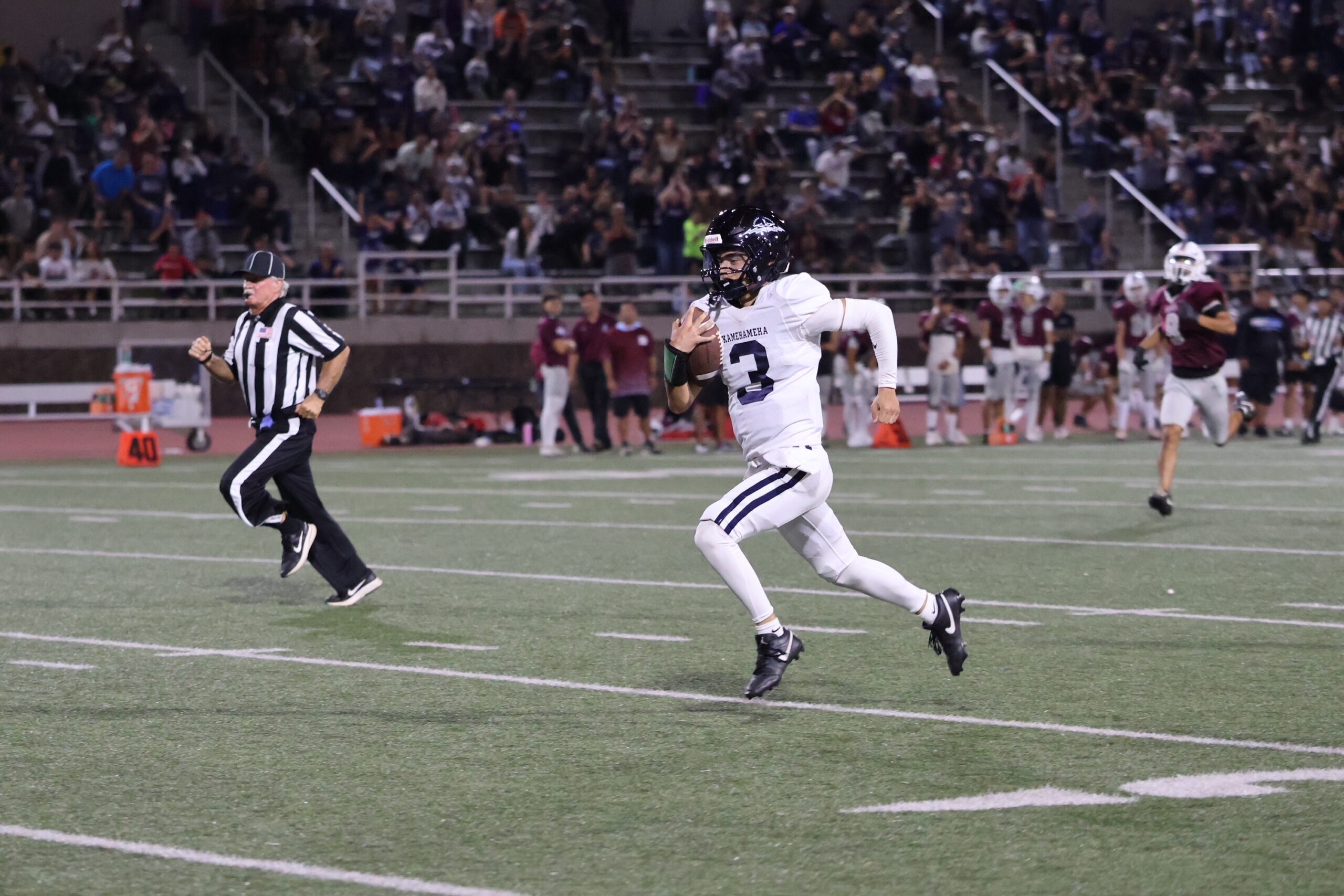 Kamehameha Schools Maui quarterback Kekoa Keau-Davis runs during a 71-yard touchdown scamper in the Warriors' 49-28 win over Baldwin on Friday night. REID YAMAMOTO photo