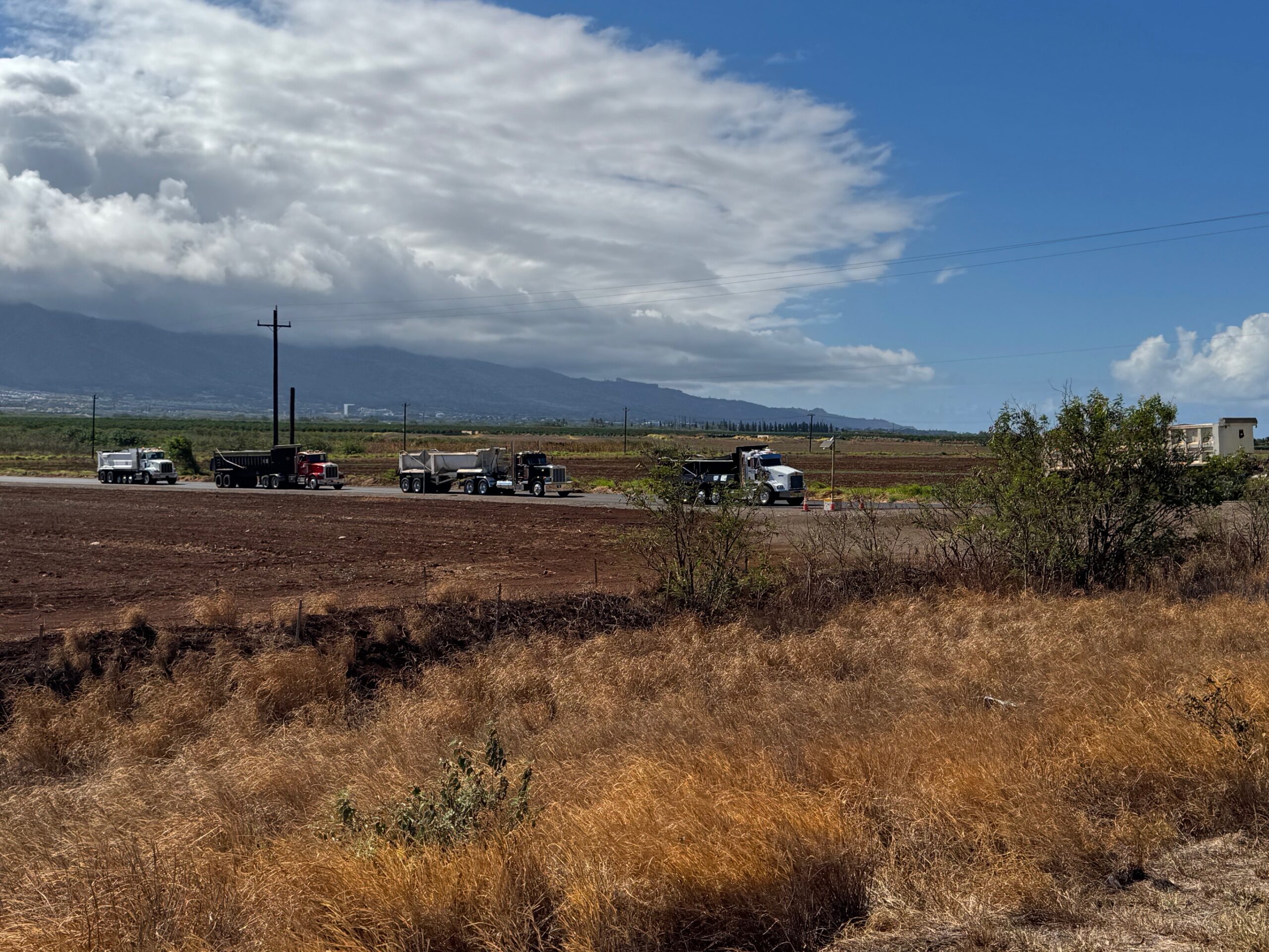 Local trucks approach the Maui Veterans Highway on their way to the Central Maui Landfill on Aug. 12. HJI / ROB COLLIAS photo