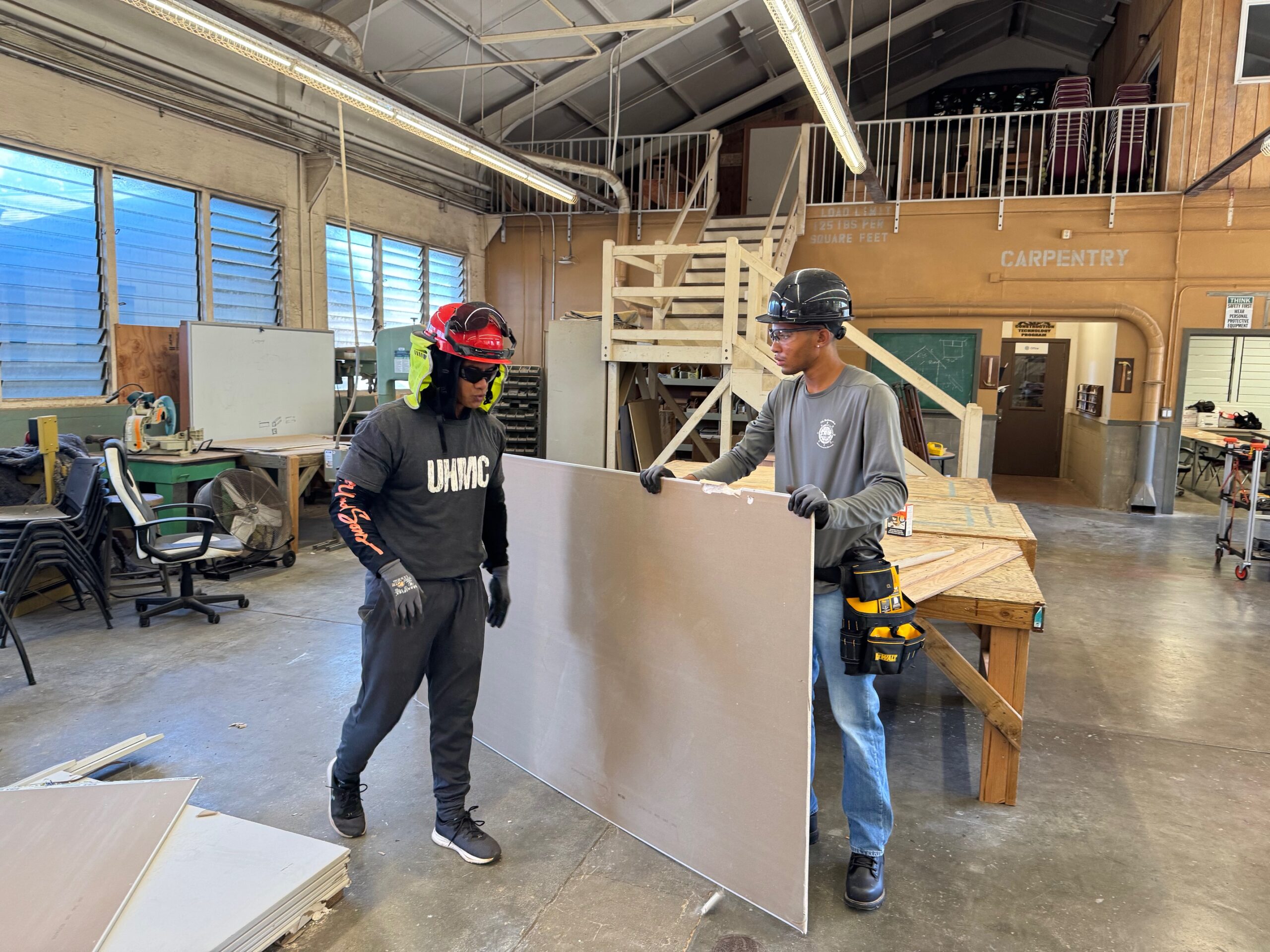 Instructor Kainoa Mahoe (right) and student Isaiah Goosby work with drywall on Monday in the University of Hawai'i Maui College carpentry room. HJI / ROB COLLIAS photo