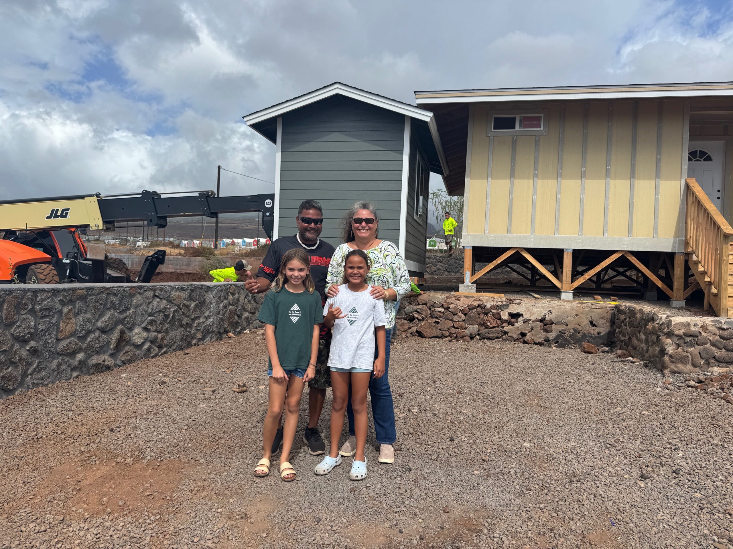 Louis and Darice Garcia stand with their 10-year-old daughter Kolokea (right front) and friend Anaya Arakawa on Thursday on their Ainakea Street lot in Lahaina. The Garcias received the 41st shed from the University of Hawai'i Maui College free shed program. HJI / ROB COLLIAS photo