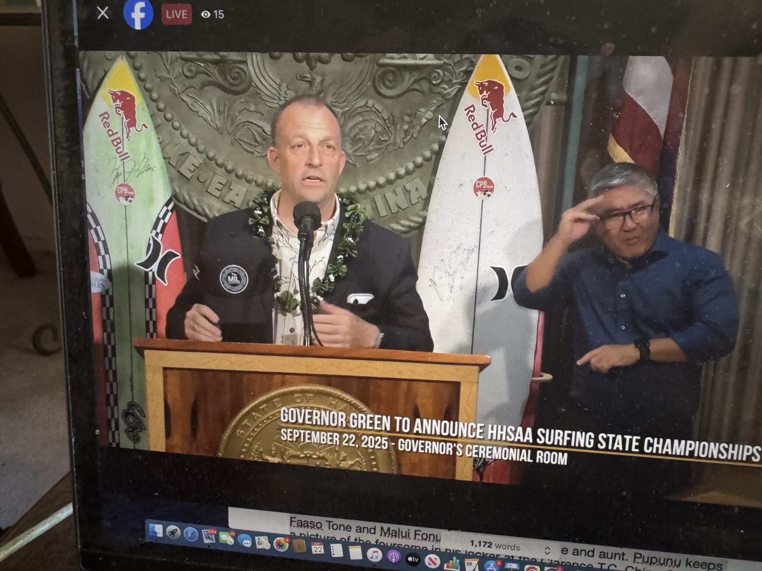 Hawai'i Gov. Josh Green holds the Maui Interscholastic League surf hat he wore during a news conference Monday at the state capitol to announce that high school surfing will have a state championship for the first time in the spring. The first state high school suring tournament will be held May 1-2, 2026, at Ho'okipa Beach Park. Screenshot photo
