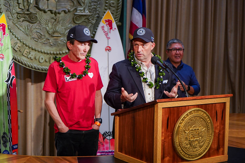 Kim Ball (left), the founder of Maui Interscholastic League surfing, answers questions at a news conference at the state capitol Sept. 21 while standing in front of Gov. Josh Green. Courtesy photo