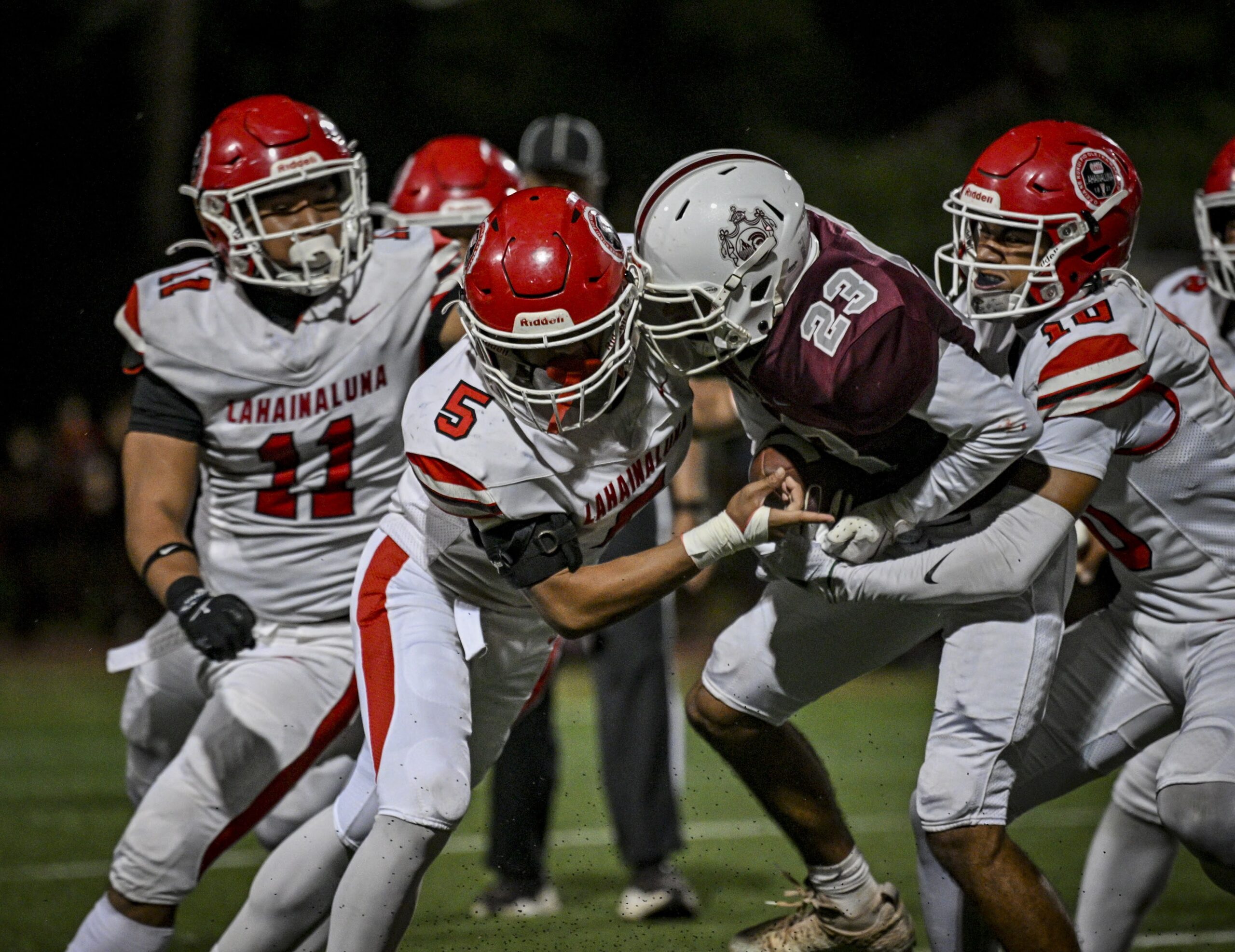Baldwin High School's Cooper Watkins is tackled by Justice Gonsalves (5) and Maui Kanekoa-Slate (10) in the Bears' 14-7 win on Saturday. GLEN PASCUAL photo