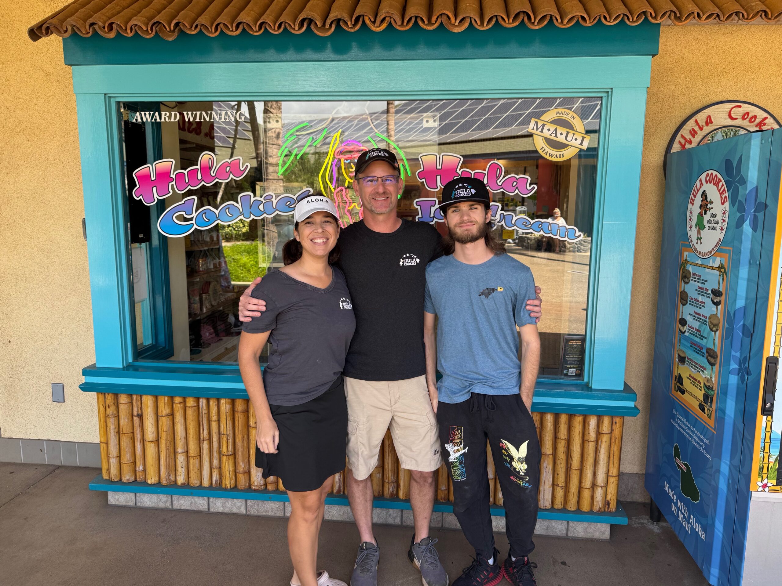 Hula Cookies owners Angie and Billy Bayer and their son Cobey stand in front of the family business in the Maui Harbor Shops in Ma'alaea on Wednesday. HJI / ROB COLLIAS photo