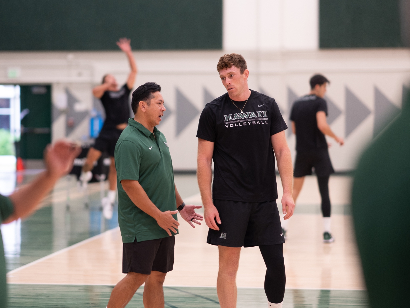 Donan Cruz (left) works with University of Hawai'i men's volleyball player Ofeck Hazan at practice on Sept. 29. Cruz, a 2001 Baldwin High School graduate, was hired as an assistant coach for the Rainbow Warriors last month. University of Hawai'i athletics photo