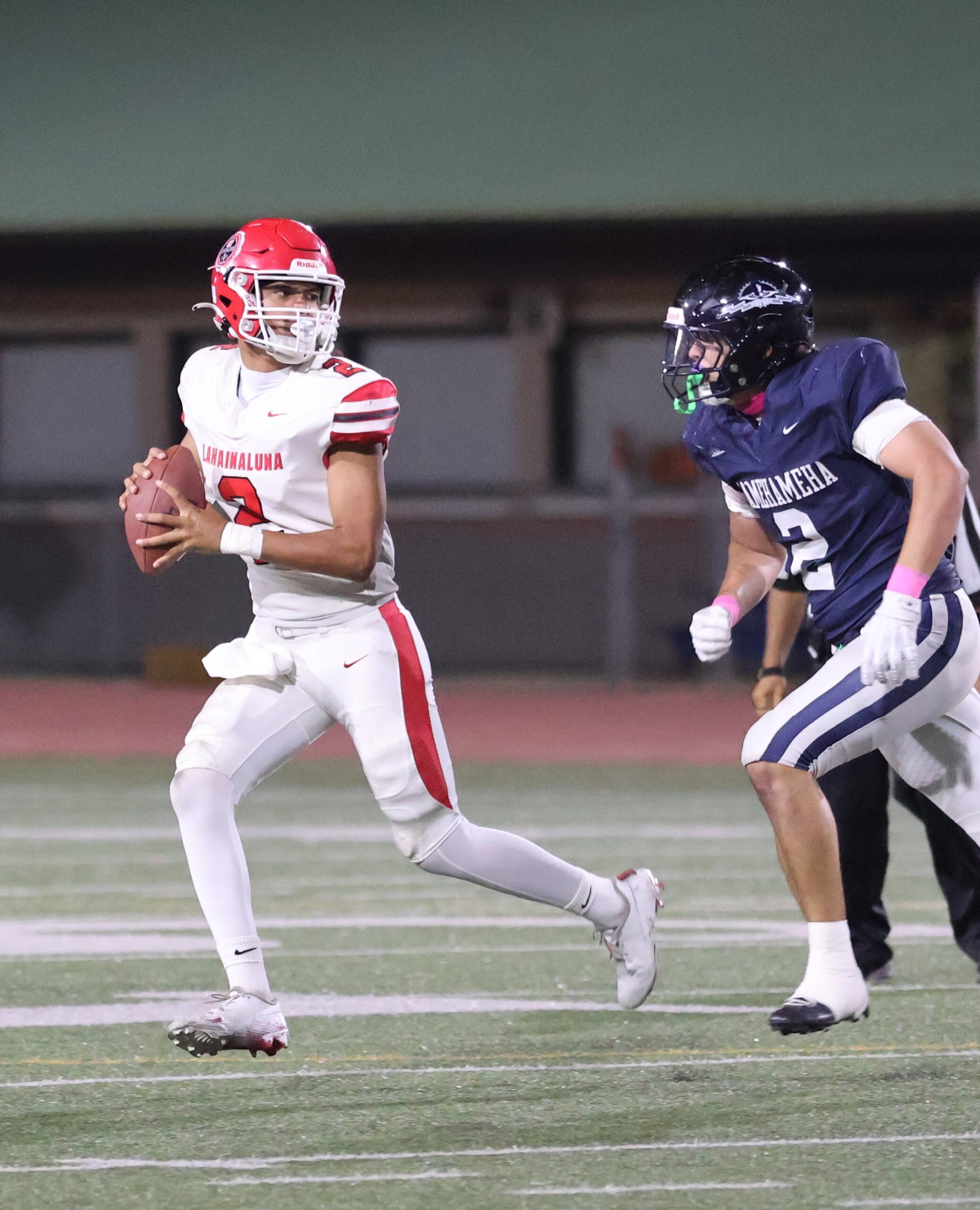 Kamehameha Schools Maui's Frank Kapohai Abreu closes in on Lahaunaluna quarterback Leka Rosenthal during the Warriors' 27-7 win over the Lunas on Friday. REID YAMAMOTO photo