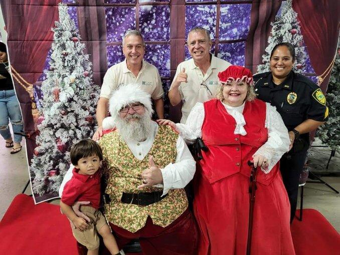 Paul Tonnessen (back row, middle) celebrated Christmas with husband Richard Carr (backrow, left), a Maui police officer, Pi'ilani Gamponia (front row left), and Santa Claus and Mrs. Claus in this 2022 photo. Courtesy photo