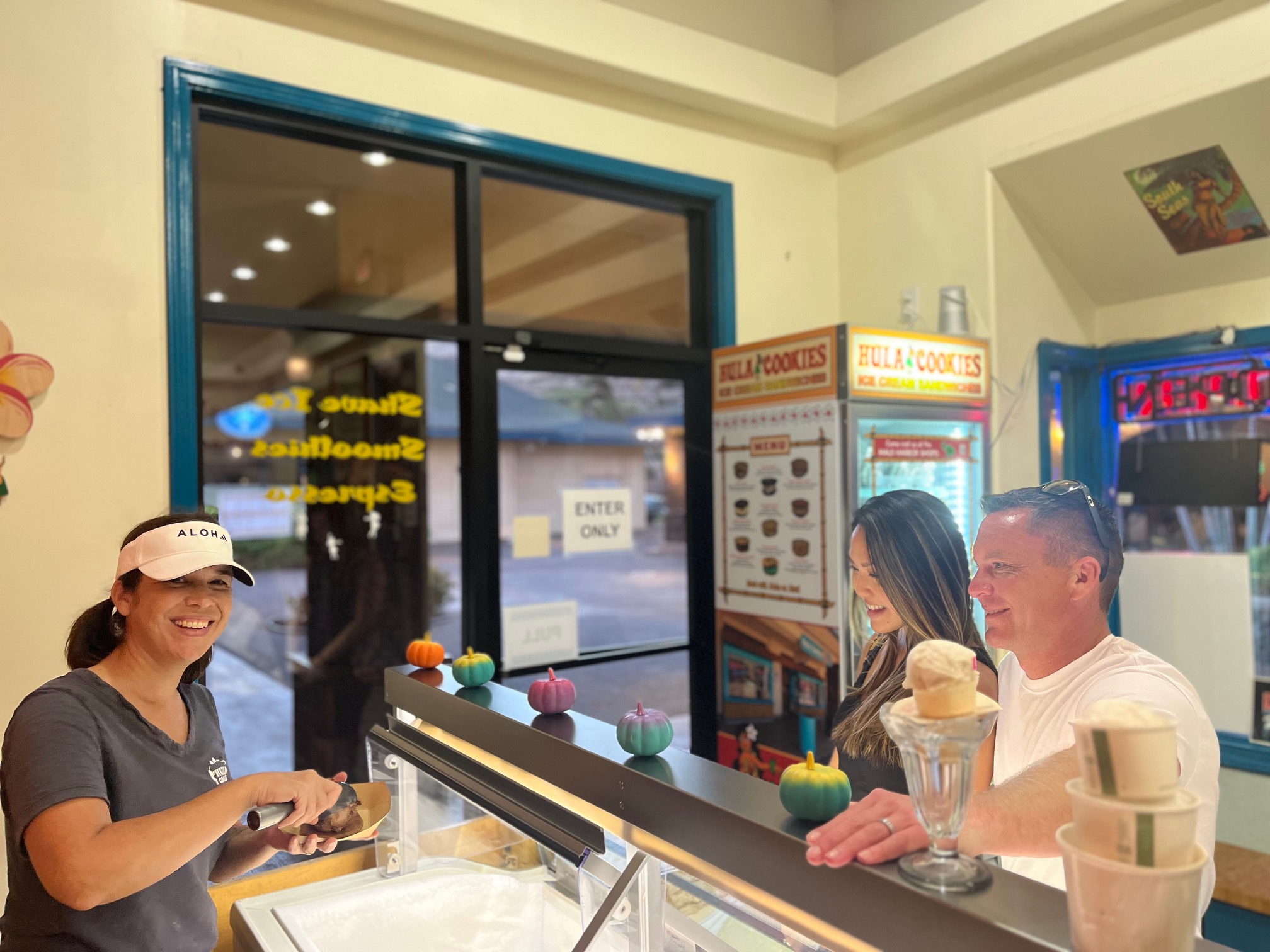Hula Cookies co-owner Angie Bayer (left) serves customers at their store in Maʻalaea store recently. Hula Cookies will be one of 140 vendors at the Made in Maui County Festival Nov. 7-8 at Maui Arts & Cultural Center. Courtesy photo