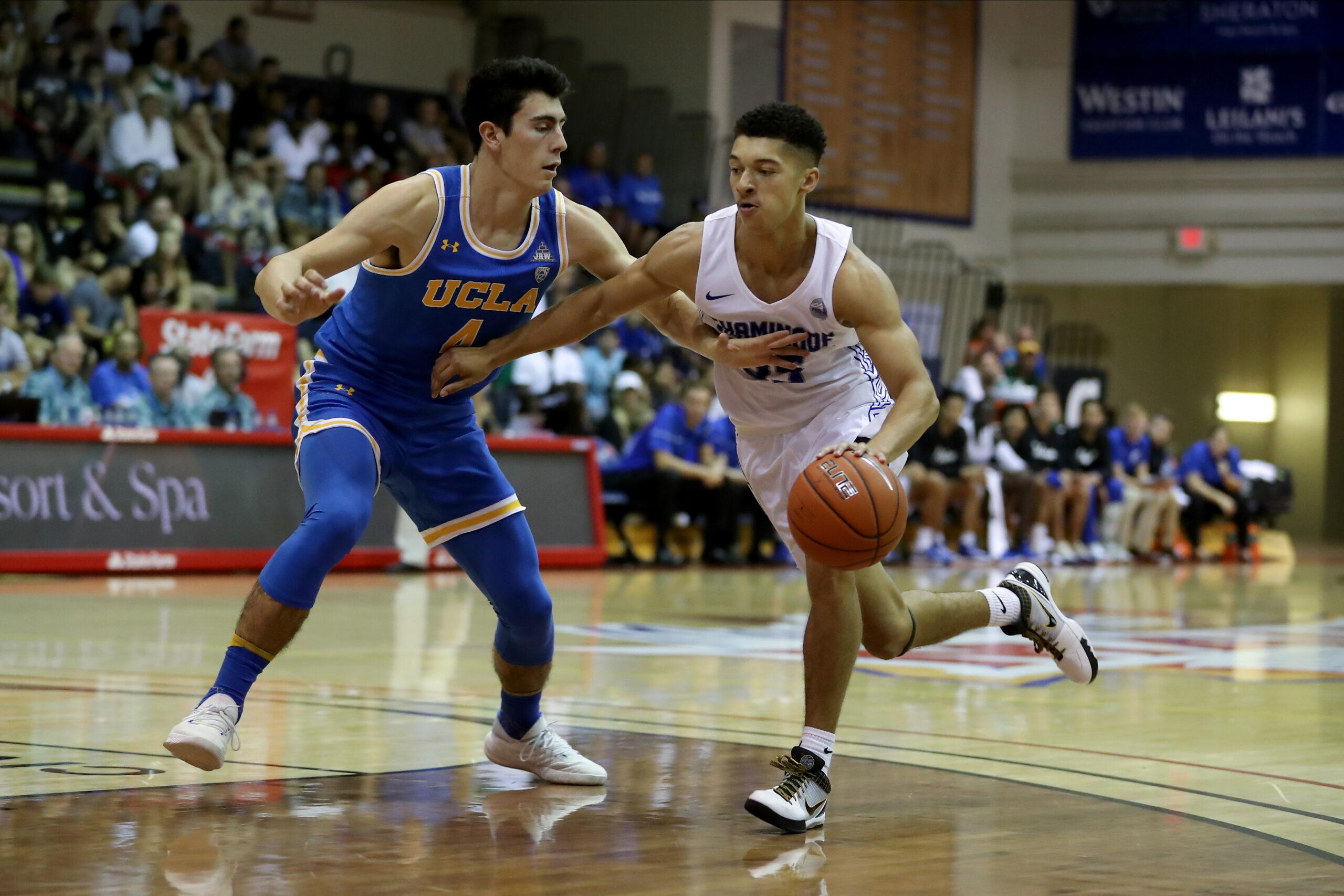 Chaminade University of Honolulu basketball player Tyler Cartaino (right) is shown on Nov. 26, 2019 at the Lahaina Civic Center in a 74-48 loss to UCLA. Chaminade University Athletics photo