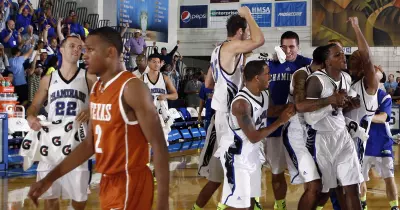 The Chaminade University of Honolulu basketball team celebrates its 86-73 win over Texas on Nov. 19, 2012. Chaminade University Athletics photo