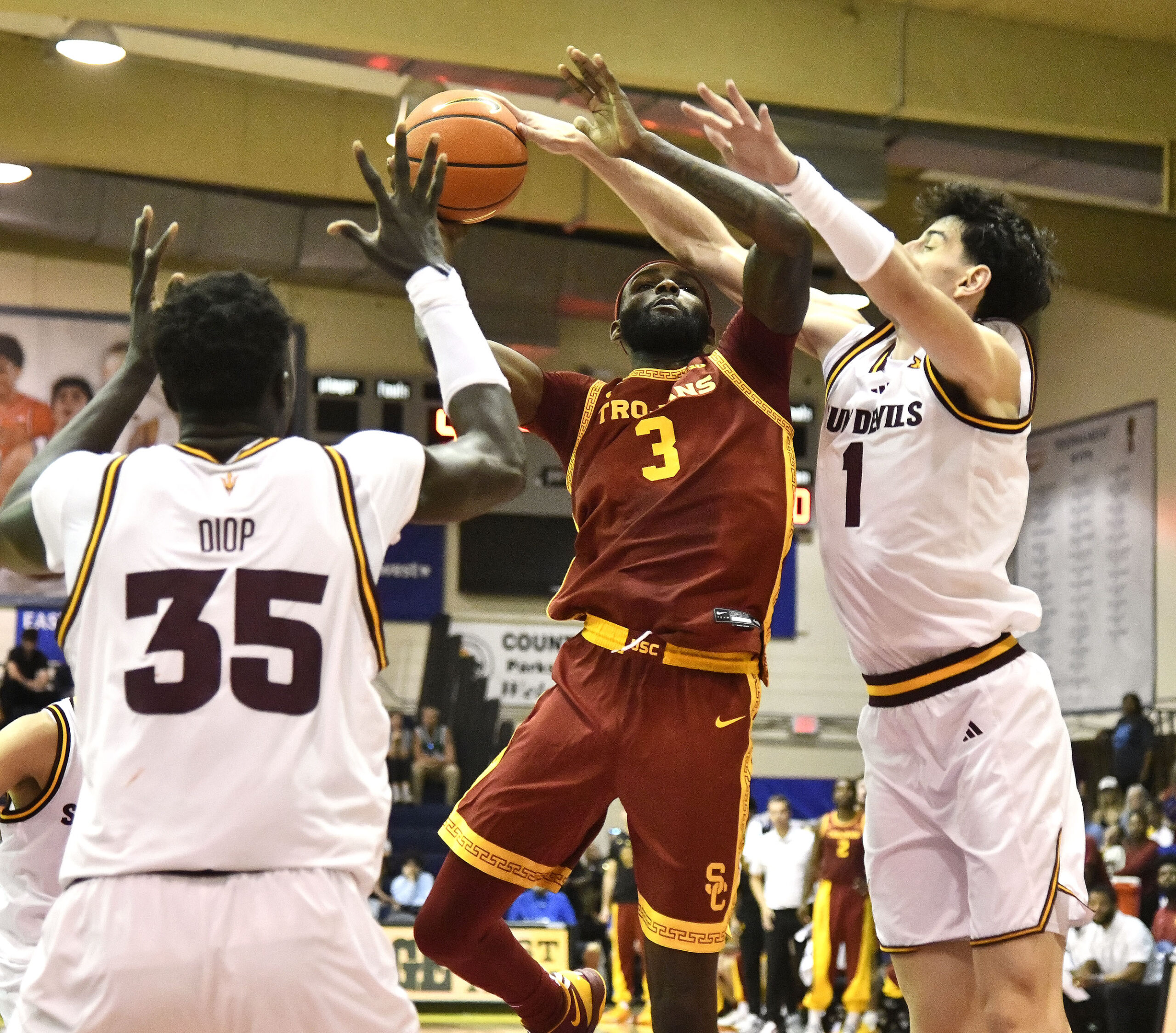 USC's Amarion Dickerson puts up a second-half shot between Arizona State's Santiago Truet (right) and Massamba Diop Wednesday. MATTHEW THAYER photo