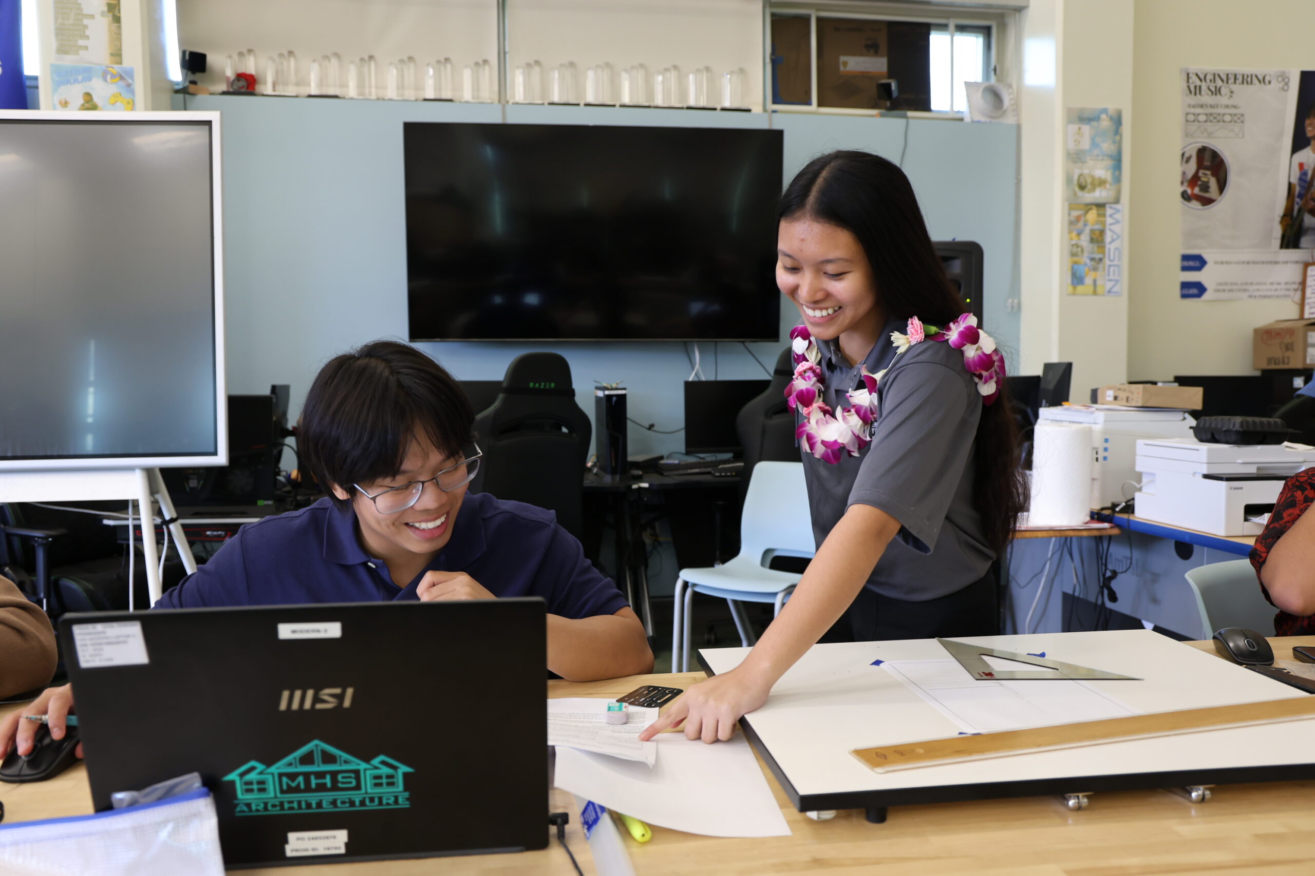 Maui High School junior Andrin Balasbas, an architectural design student, shows his work to host Jamaeia Espanol, a senior, on Friday. ALEIZAY ANGEL photo
