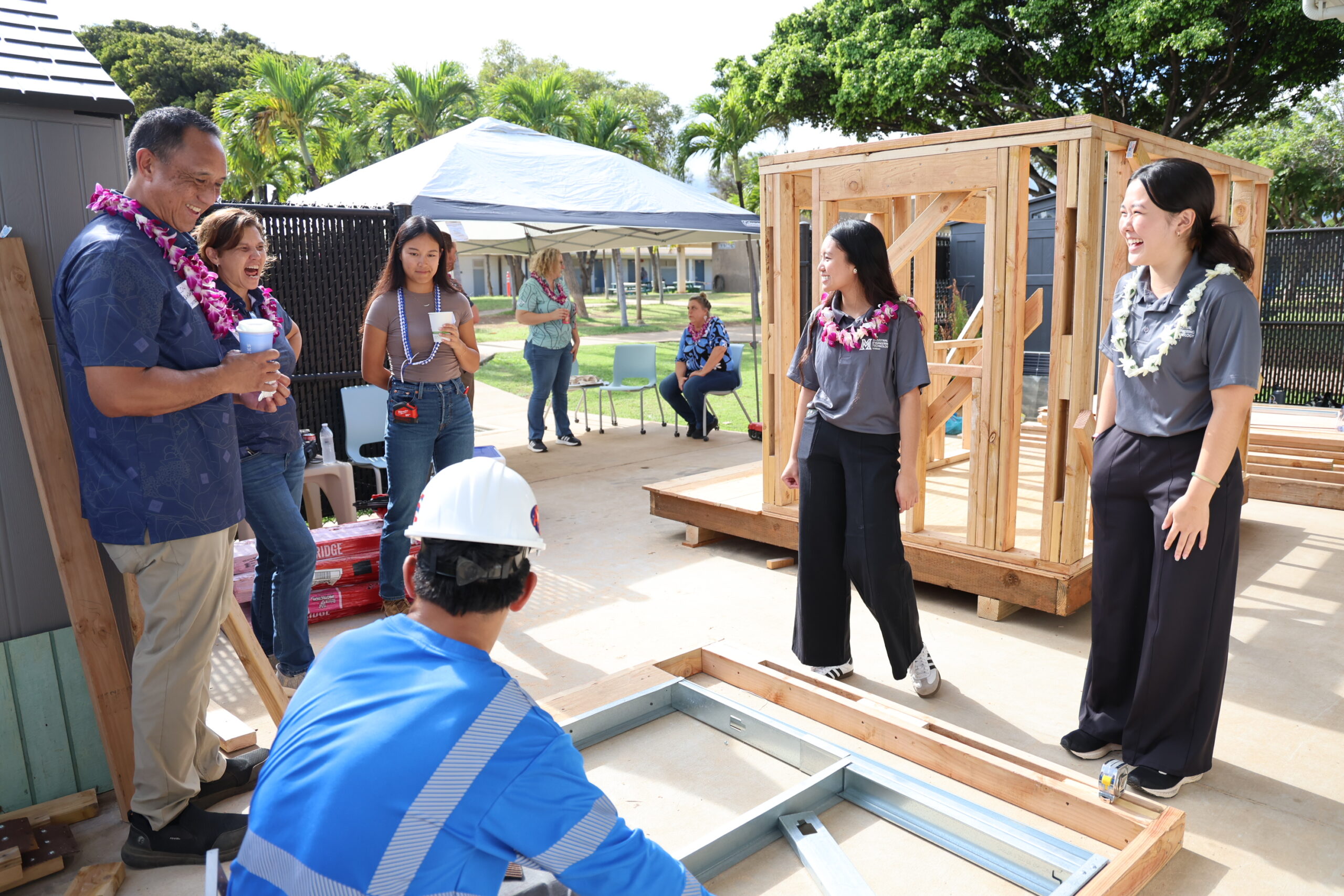 Maui High School student hosts Jamaeia Espanol (middle) and Kaylee Yagi (right) talk with construction showcase students at the school on Friday. ALEIZAY ANGEL photo
