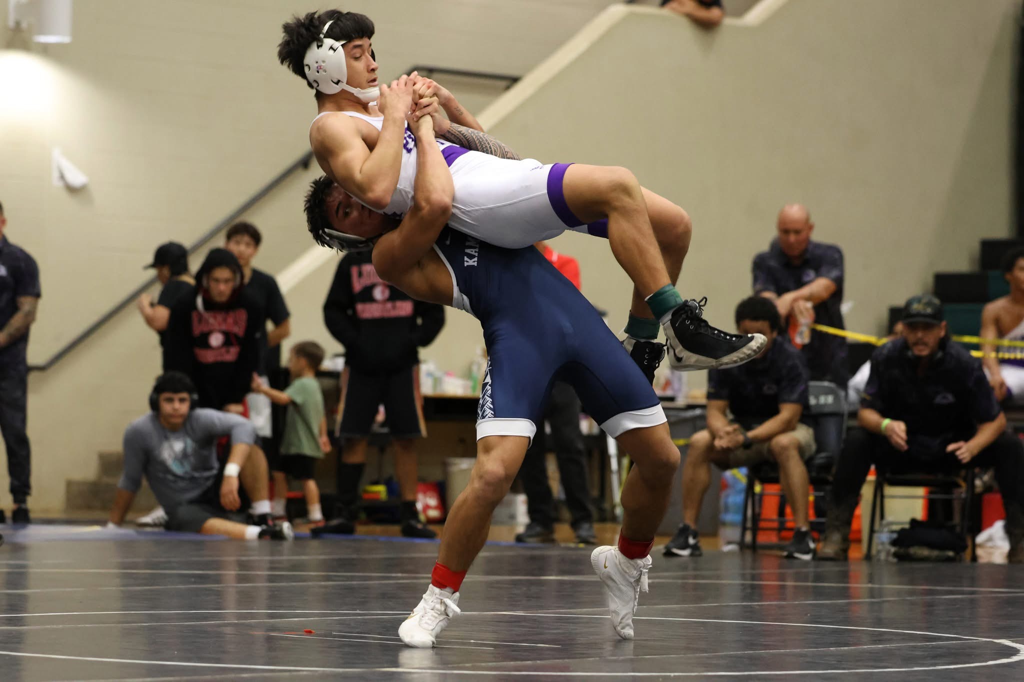 Kamehameha Schools Maui's Blake Abernathy (back) throw Pearl City's Miles Uyemura III in their 144-pound final at the Garner Ivey Maui Invitational Wrestling Tournament. Abernathy won the match 1-0. JASON HAYASE photo
