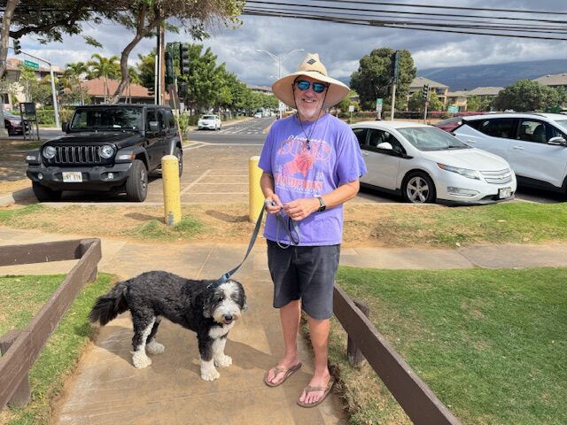 Maui resident Jim Ogsbury and his 6-year-old sheepadoodle "Captain Goodboy" enjoyed their walk at Kama'ole Beach Park I on Monday. HJI / ROB COLLIAS photo