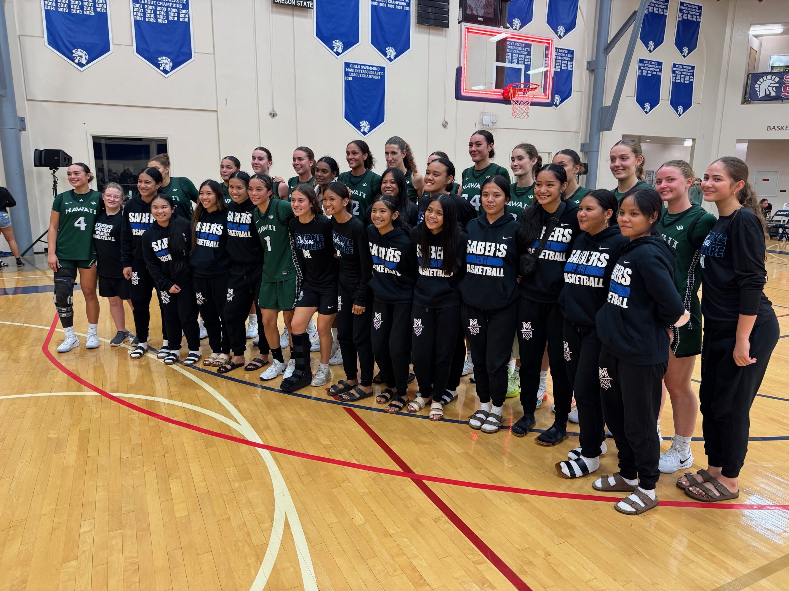 The University of Hawai'i women's basketball team poses for a post-game photo with the Maui High School girls team on Friday at Seabury Hall. HJI / ROB COLLIAS photo