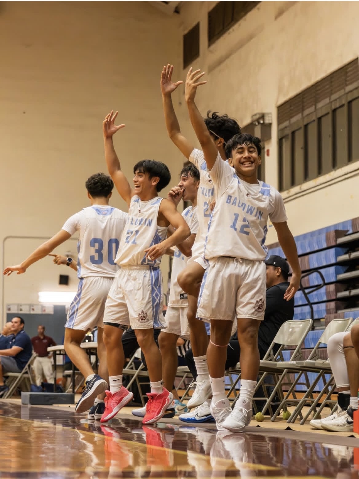 The Baldwin High School boys basketball bench celebrates during a game ealrlier this season. Most of these players are starters who are cheering on their younger substitute teammates. KIM TENGAN photo