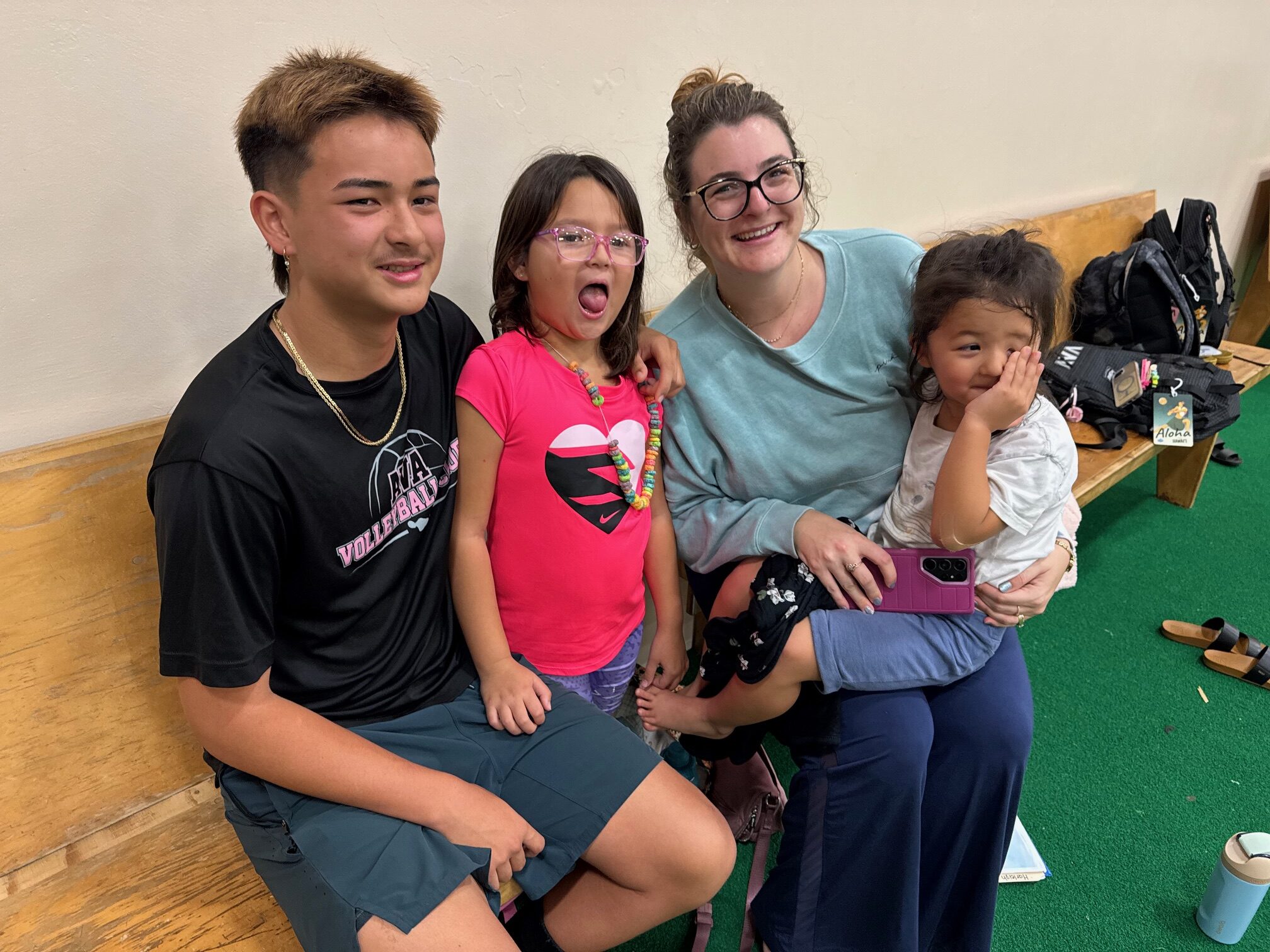 The Jeoung family sits together at Aloha Volleyball Association practice on Thursday. From left: Ivan Jeoung, 14; Harleigh Jeoung, 7; Tonya Jeoung, mom; and Korra Jeoung, 4. HJI / ROB COLLIAS photo