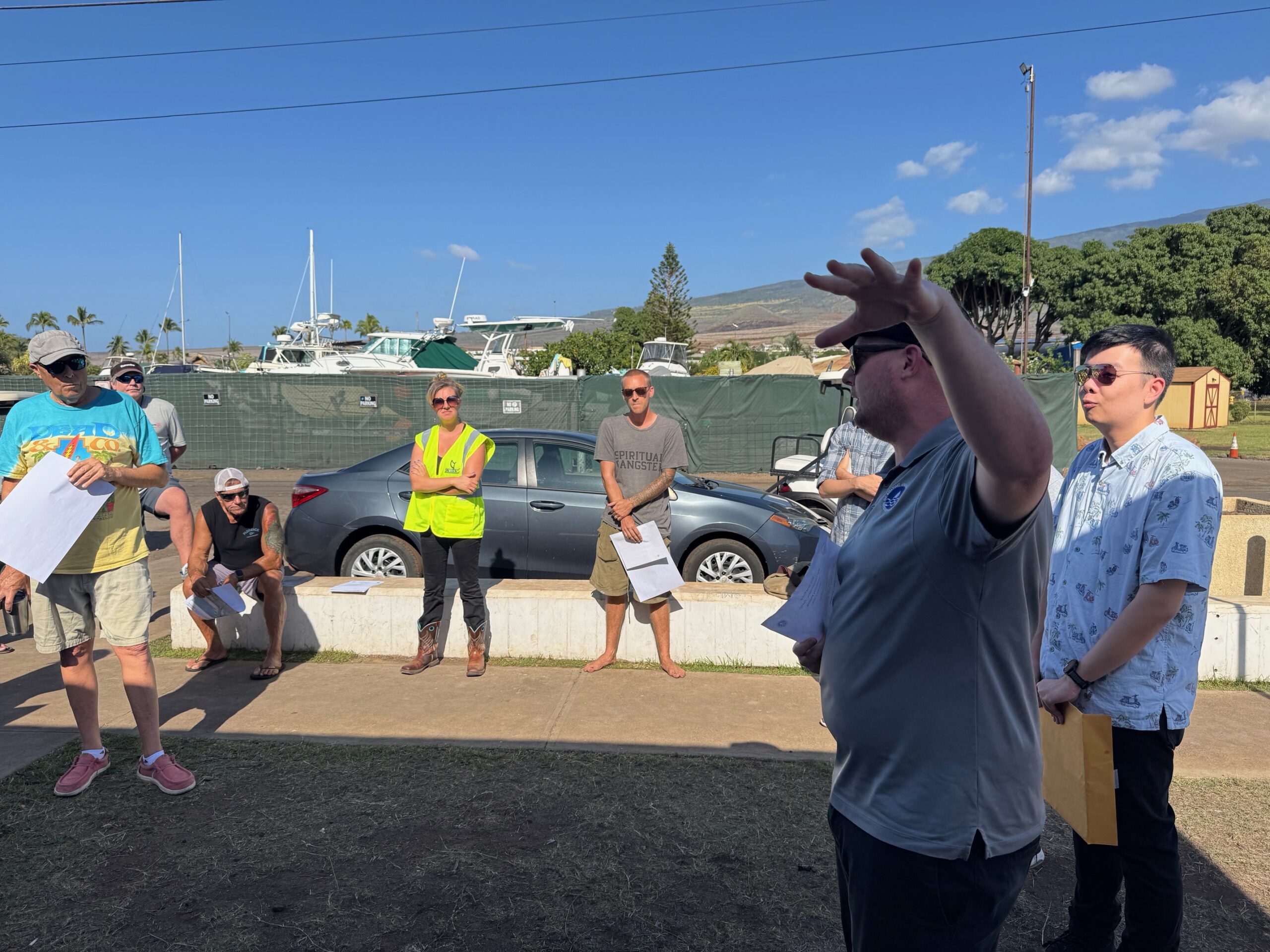Finn McCall (arm raised), an engineer for the state Department of Boating and Ocean Recreation, speaks at a community meeting on Wednesday to outline the renovations set to be done at the Mala Boat Ramp. HJI / ROB COLLIAS photo