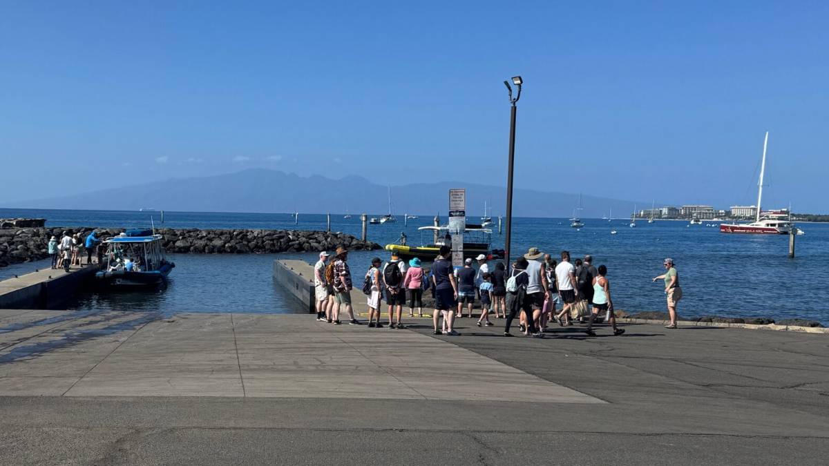 One commercial boat loads passengers as another approaches at Mala Boat Ramp on Wednesday afternoon. HJI / ROB COLLIAS photo