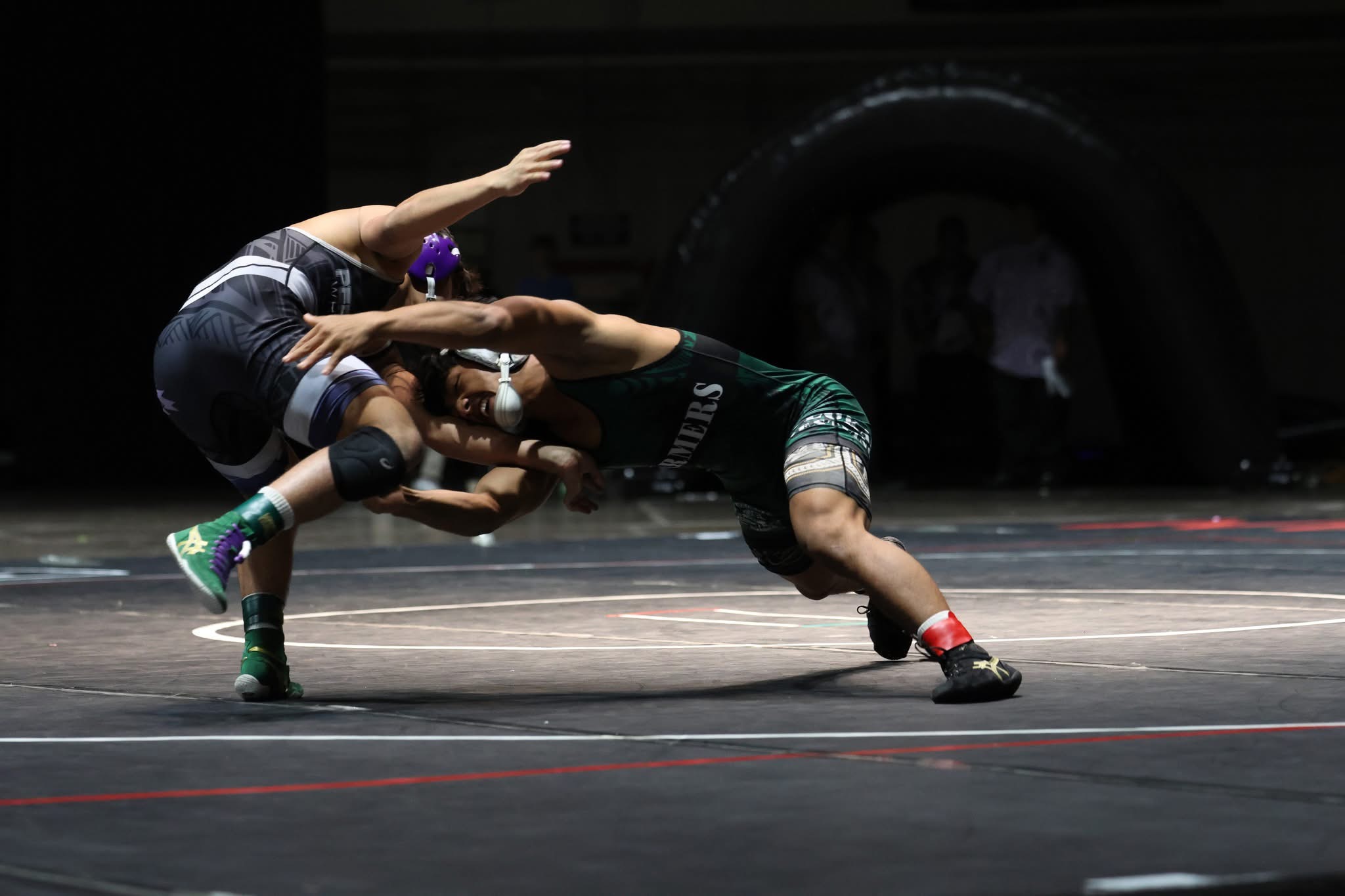 Moloka'i High School's Jona Dudoit (right) goes for a shot against Pearl City's Irving Bicoy in Dudoit's 4-3 win in the 126-pound state championship match on Saturday at the Blaisdell Arena on O'ahu. JASON HAYASE photo
