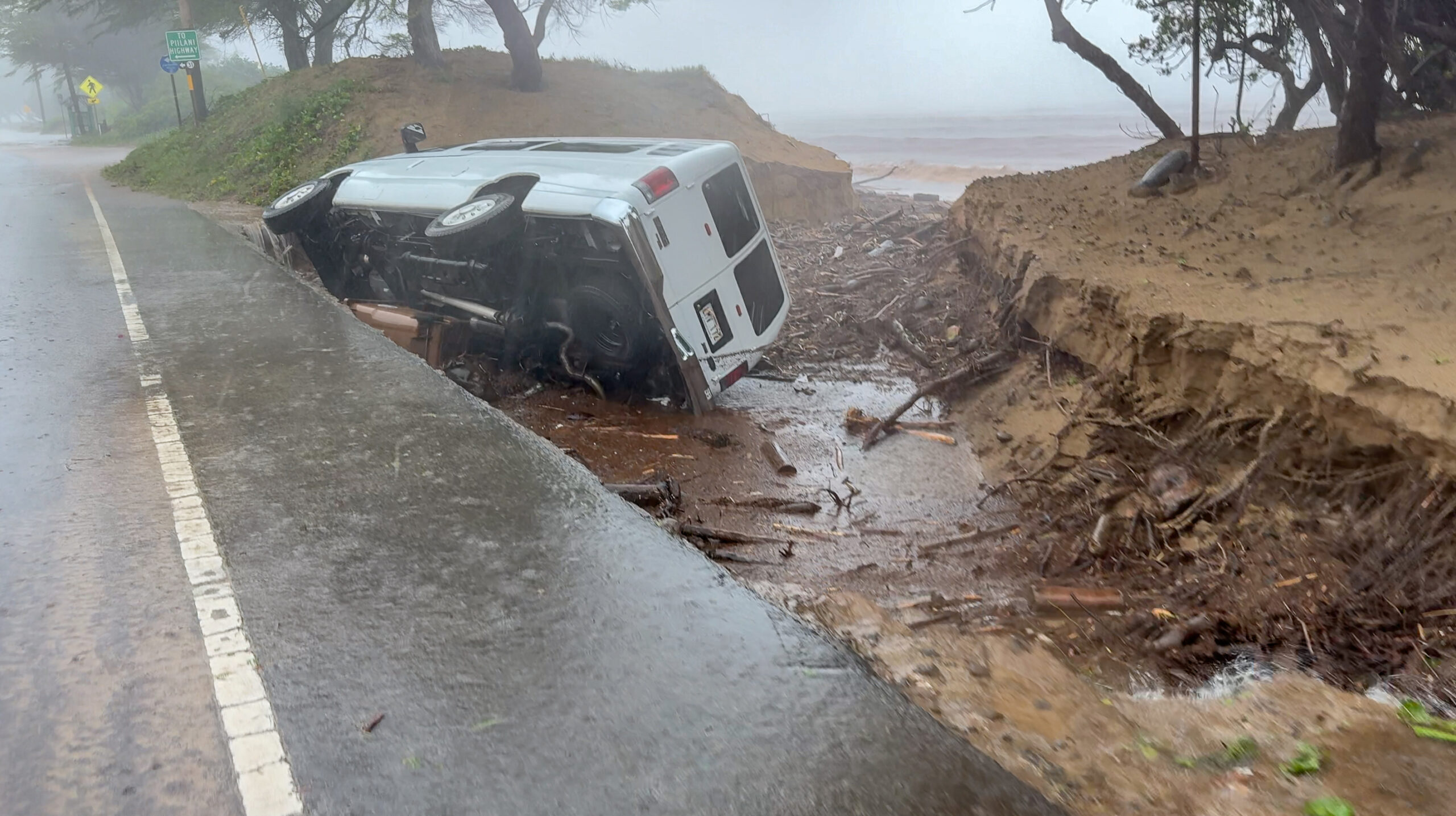 The ground beneath a white van on S. Kīhei Road was washed out, leaving the vehicle sideways on March 14, 2026. HJI / Cammy Clark photo