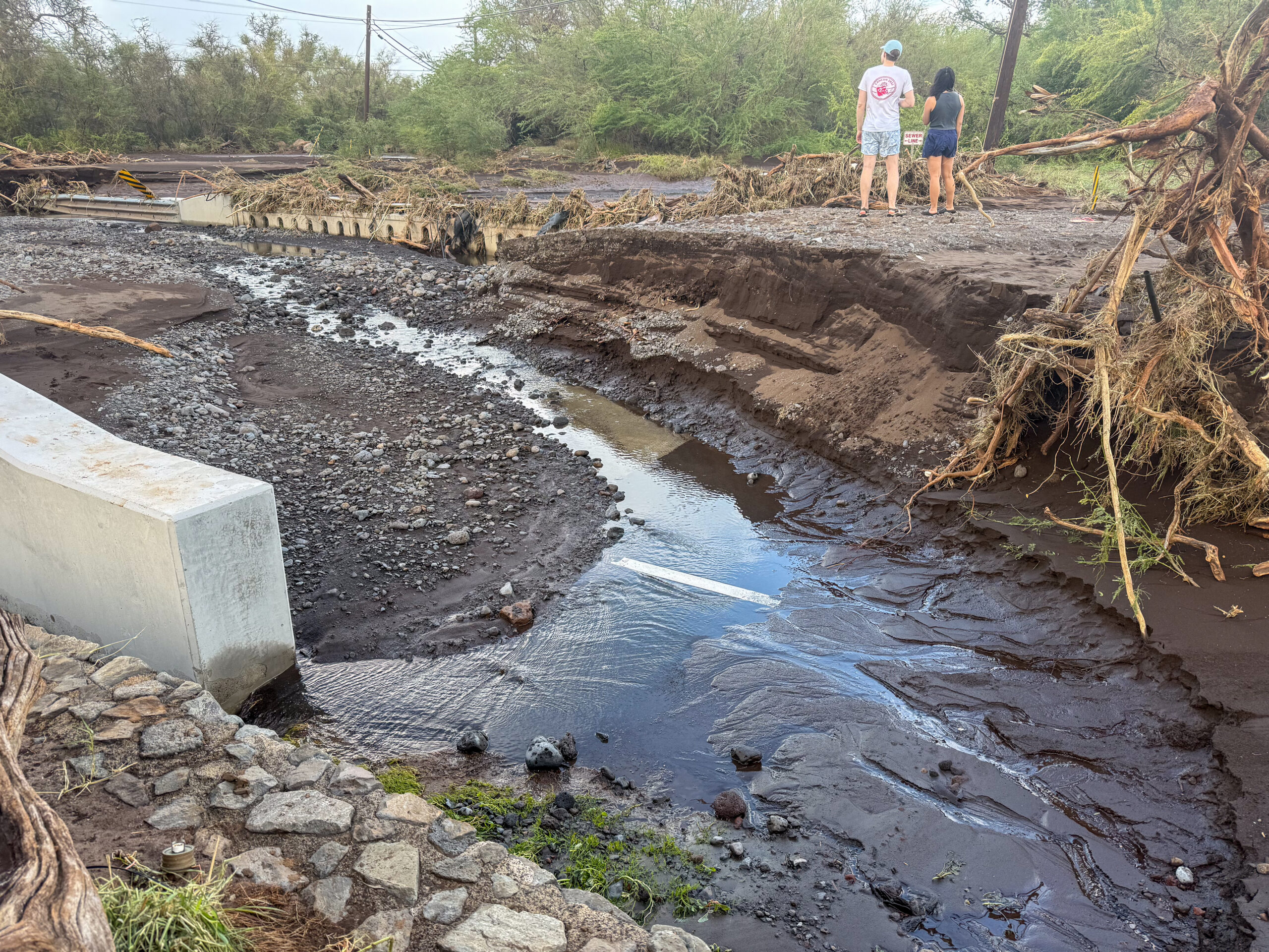 The bridge at the north end of S. Kīhei Road was inundated with mud and debris, causing much floodwater and mud to divert down the road and make it impassable during the Kona low storm of March 13 and 14, 2026. HJI / Cammy Clark photo