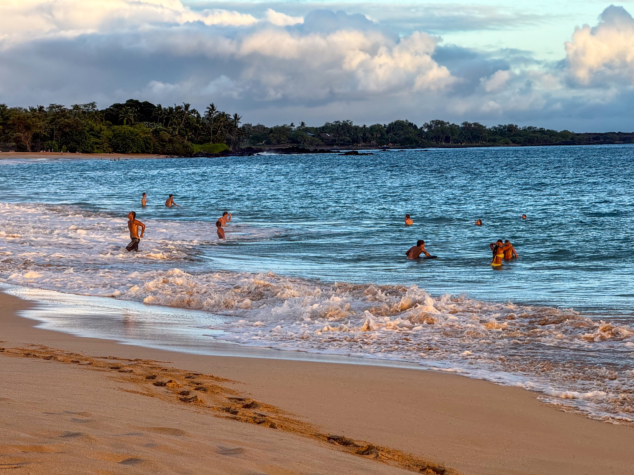 Several teenagers played in the waves at Makena State Park on June 23, 2026. HJI / Cammy Clark photo