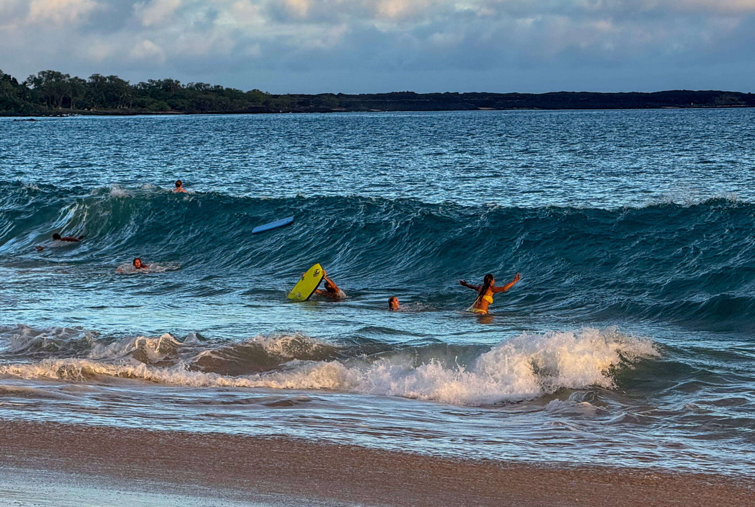 Several teenagers played in the waves at Makena State Park on June 23, 2026. HJI / Cammy Clark photo