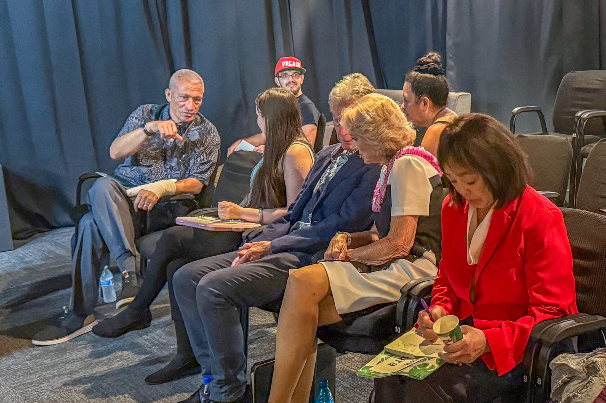 Some of the mayoral candidates talk with each other or study their notes before the Kīhei Community Association forum on June 16, 2026, at the ProArts Playhouse. HJI / CAMMY CLARK photo